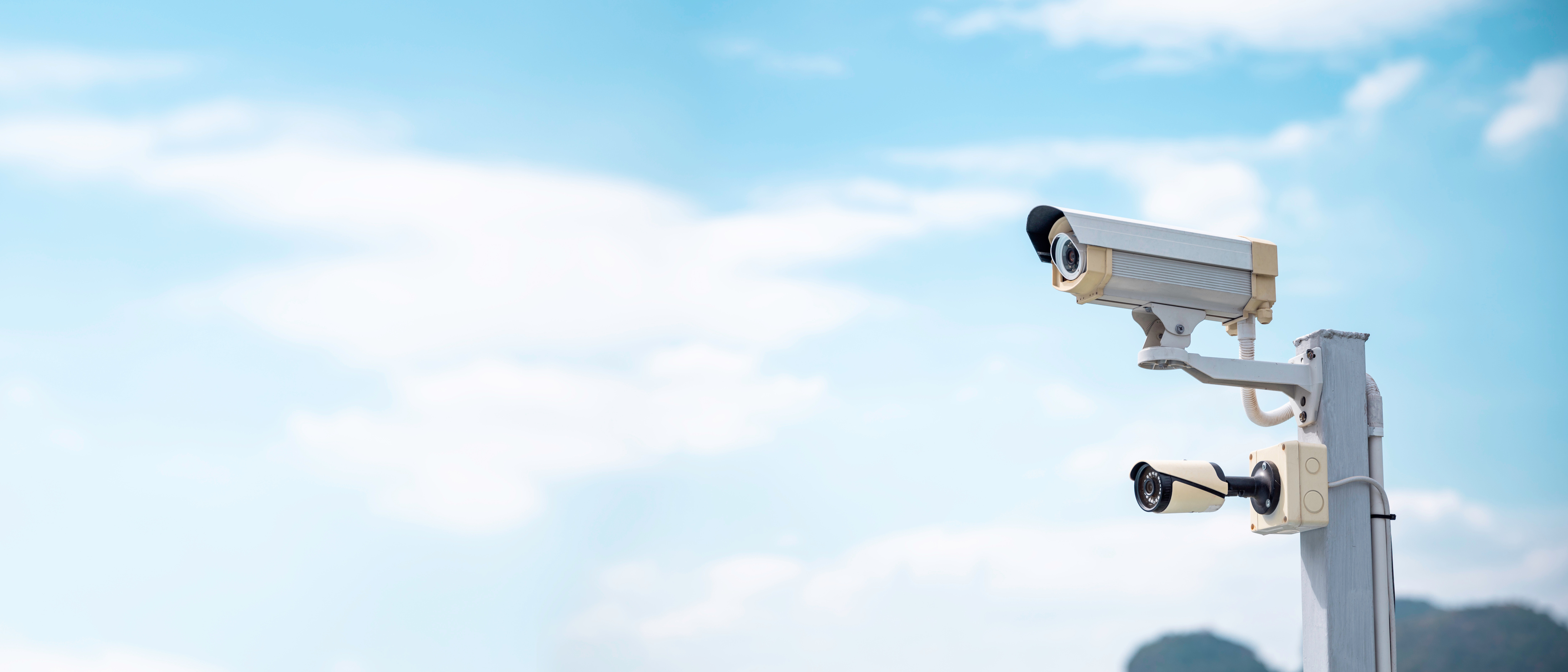 Modern CCTV security system on sky background Smart camera theft protection.